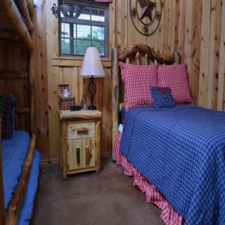Twin bunk beds and full bed in Americana room at Three Falls Cove