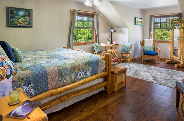 Astoria room view with bistro table and chairs with a view of countryside.