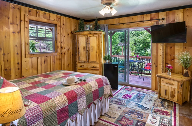 Queen bed with sliding glass door to the patio.