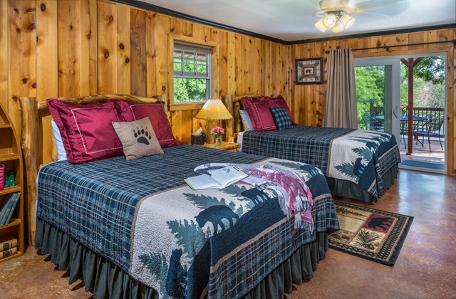 Two queen beds with sliding glass door to patio at Three Falls Cove